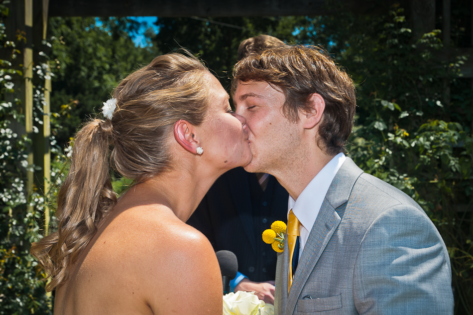 Young couple kisses I do at Park of Roses in Columbus