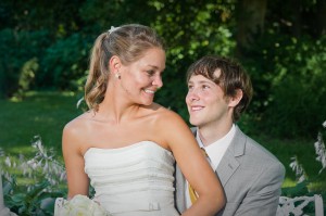 bride-smiling-at-groom-on-bench-park