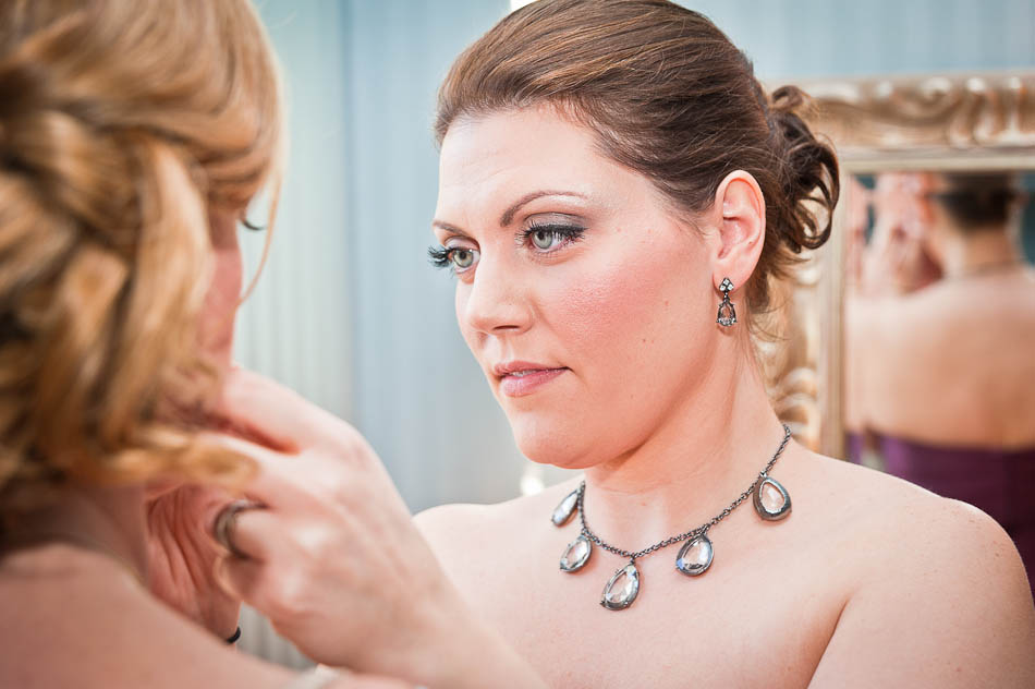 Close up of maid of honor getting bride ready