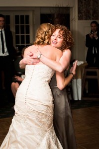 Bride-hugging-guest-during-wedding-reception