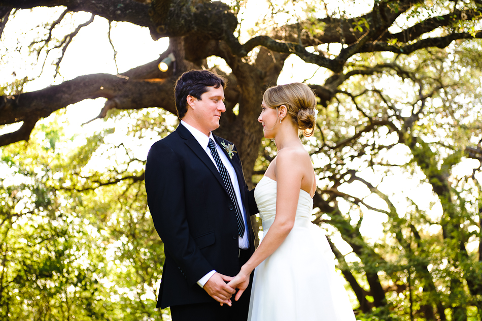 Bride and Groom holding hands under a canopy of trees