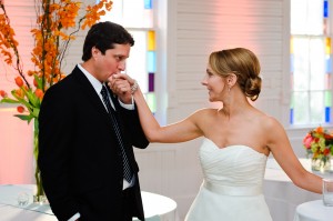 groom-kissing-brides-hand-stained-glass