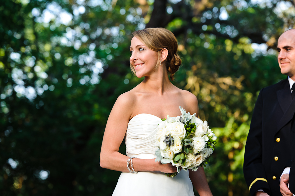 bride looking over her shoulder at groom during ceremony 