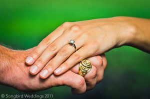 weddings-rings-holding-hands-detail