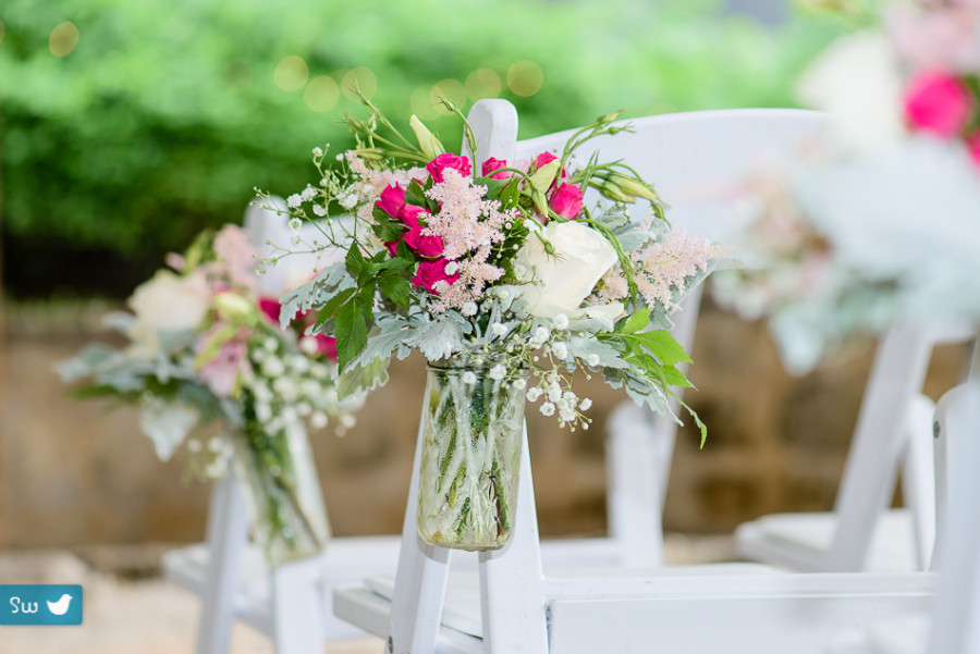 ceremony detail flowers hanging from chairs