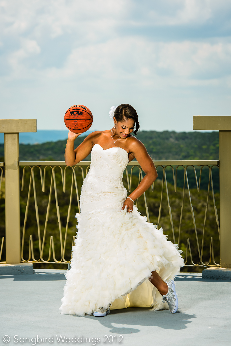 bride holding basketball while showing off sparkly converse at villa antonia