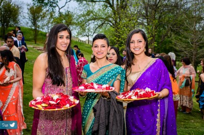 Young girls of the family ushering during baraat with Aarti trays loaded with petals and diyas (lamps)