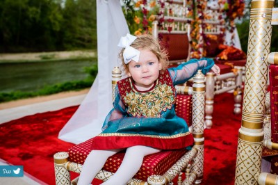 Child at Indian Hindu wedding sitting on the stage after the ceremony