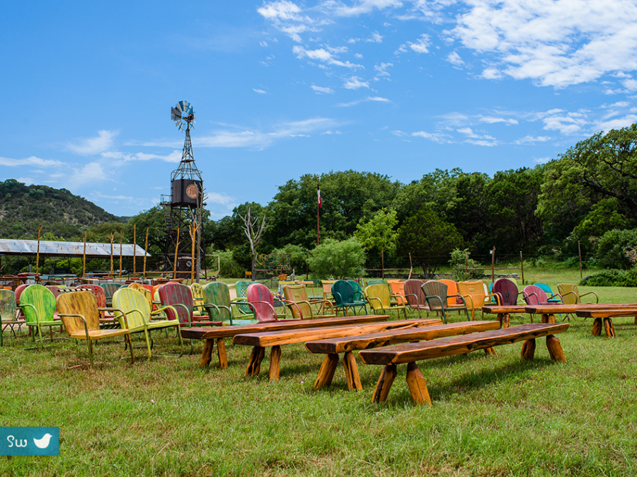 Cermeony setting with rustic painted metal chairs and windmill at Montesino Ranch by Austin Wedding Photographer