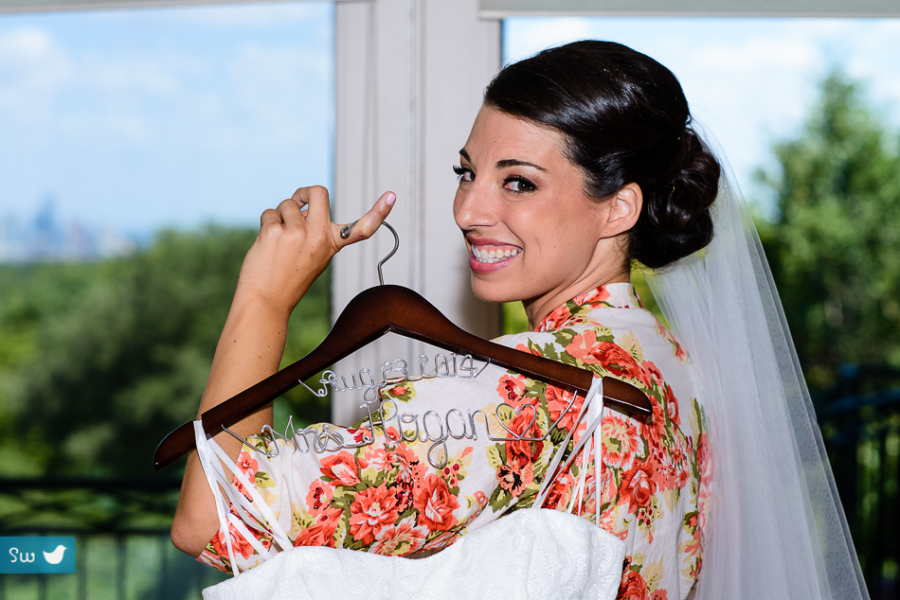 Bride with custom hanger and wedding dressby Austin Wedding Photographer