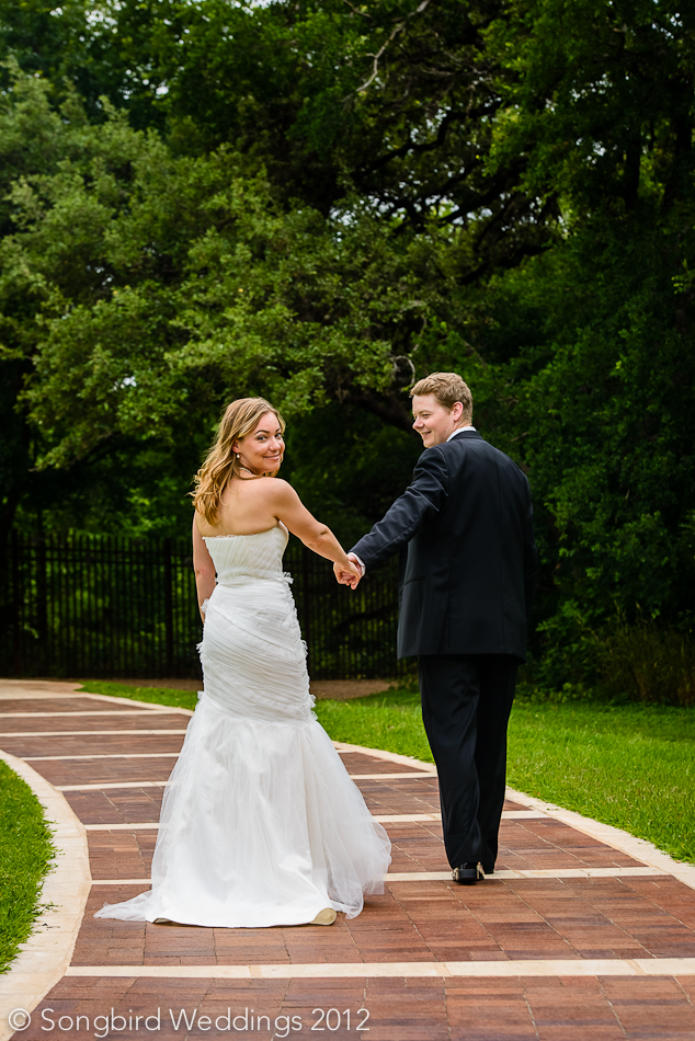 bride and groom on zilker botanical garden walkway in austin