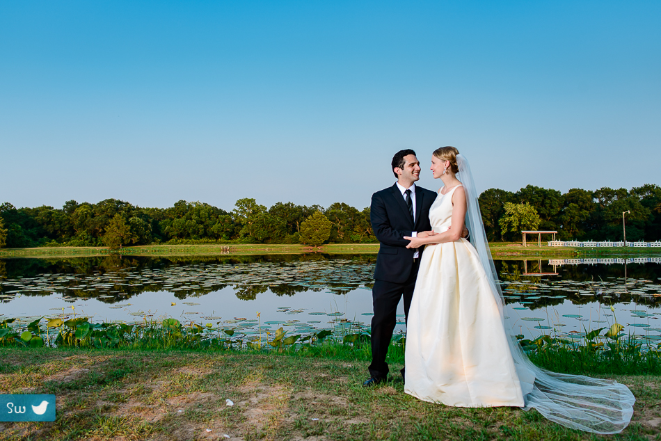 Portraits next to lake of bride and groom by Austin wedding photographers