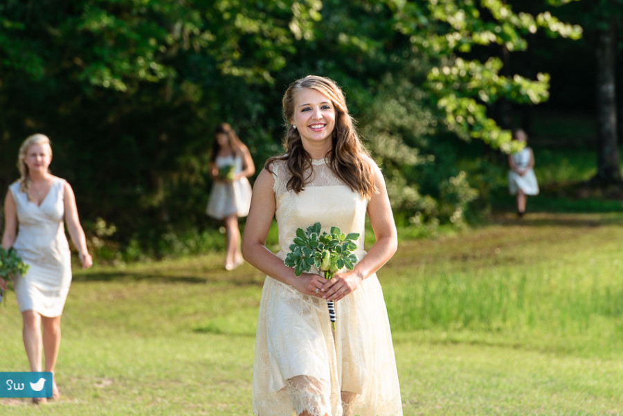 Bridesmaid walking to ceremony by Austin wedding photographers