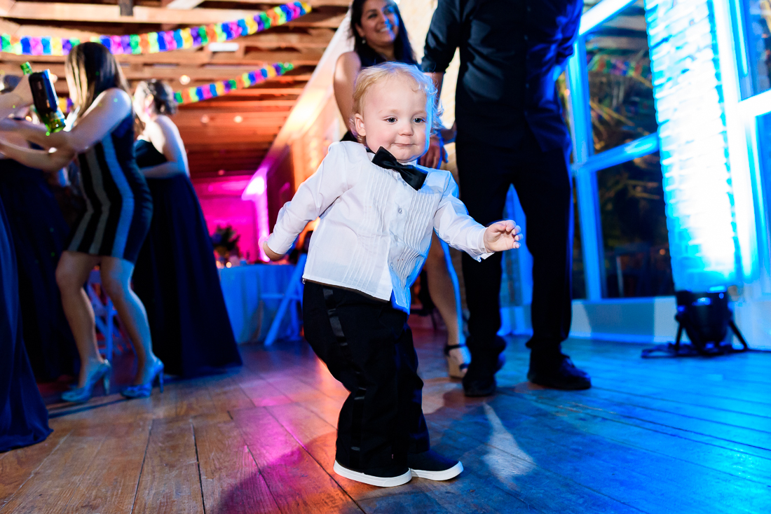 Photo of child dancing by austin wedding photographers at ZaZa Gardens in San Antonio