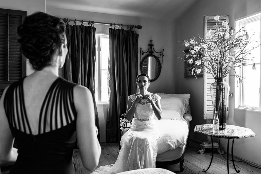 Fine art portrait of bride getting ready with sister at Le San Michele venue