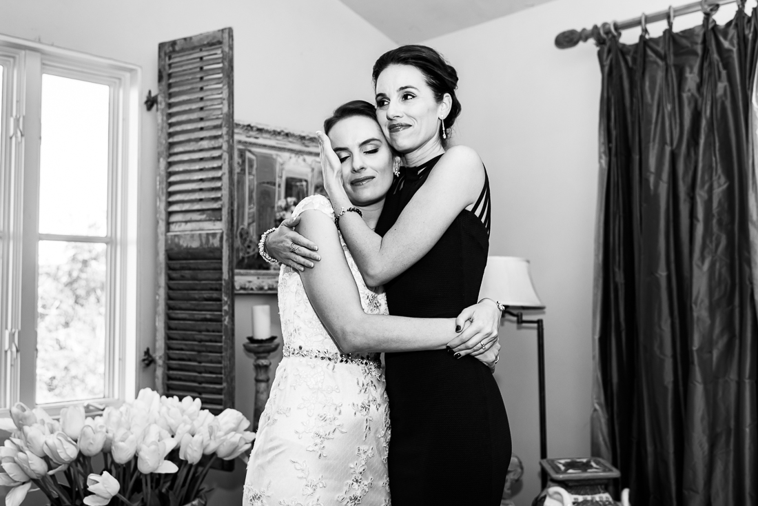 sister hugging bride at le san michele by austin wedding photographers