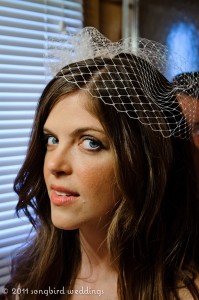 Close up of bride getting ready wearing veil