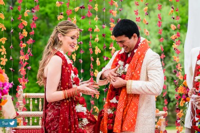 Humorous moment of groom trying to take wedding ring off his right hand