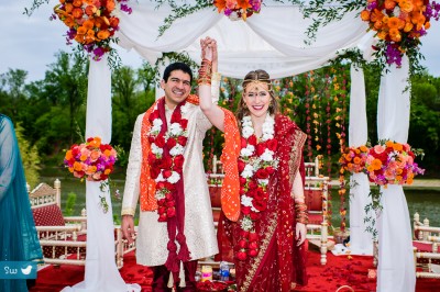 Hindu Indian wedding ceremony with groom and bride wearing red sari