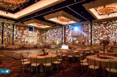 Indian Hindu wedding reception ballroom at Hyatt Lost Pines with Mehndi light projections