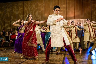 Indian Hindu Wedding reception bride and groom performing choreographed dance to Bollywood song