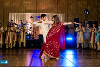 Indian Hindu Wedding reception bride and groom performing choreographed dance to Bollywood song