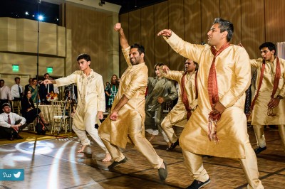 Indian Hindu Wedding reception guests performing choreographed dance to Bollywood song