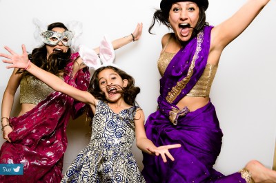 Guest having fun at indian wedding photobooth