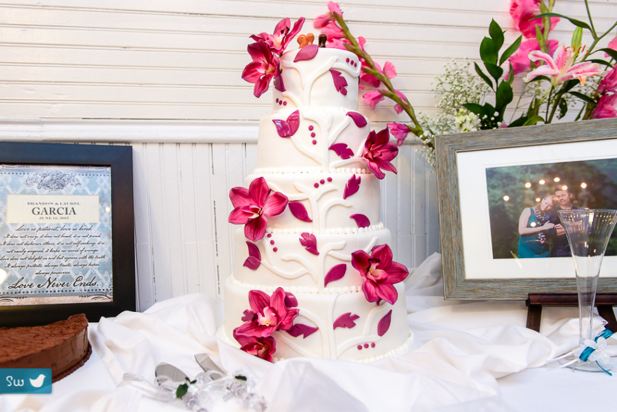 tiered cake with purple flower by photographer in austin