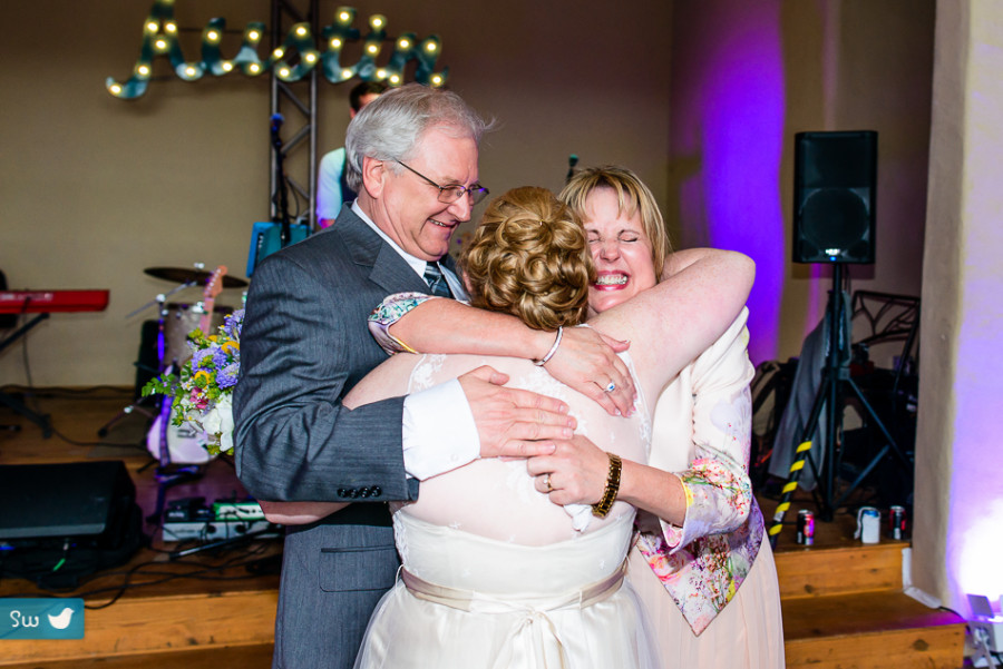 family hugging bride by Austin Wedding Photographer at Barr Mansion