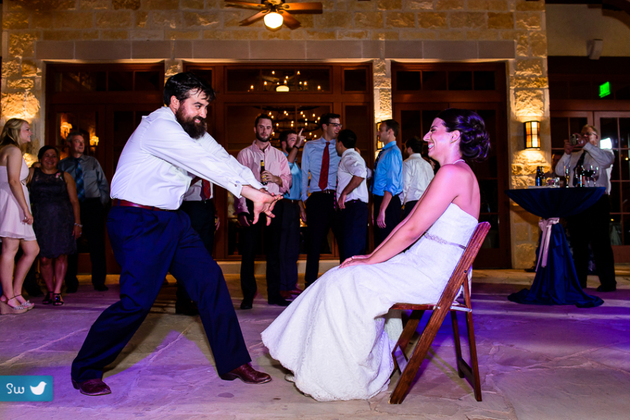 Funny moment with groom before retrieving the garter from his bride at UT Golf Club by austin wedding photographer