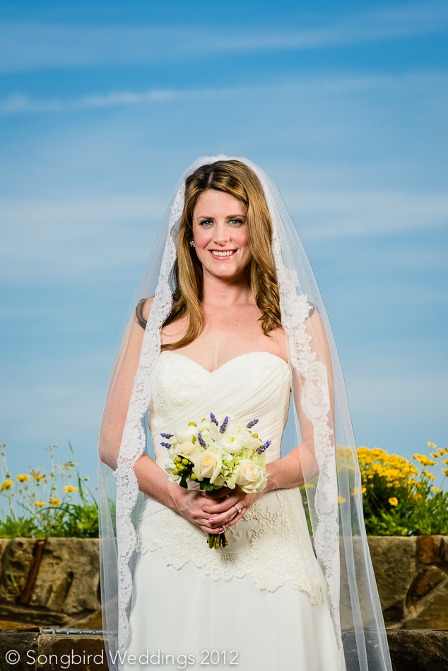 bride with veil holding bouquet at  Wildflower Center wedding in austin