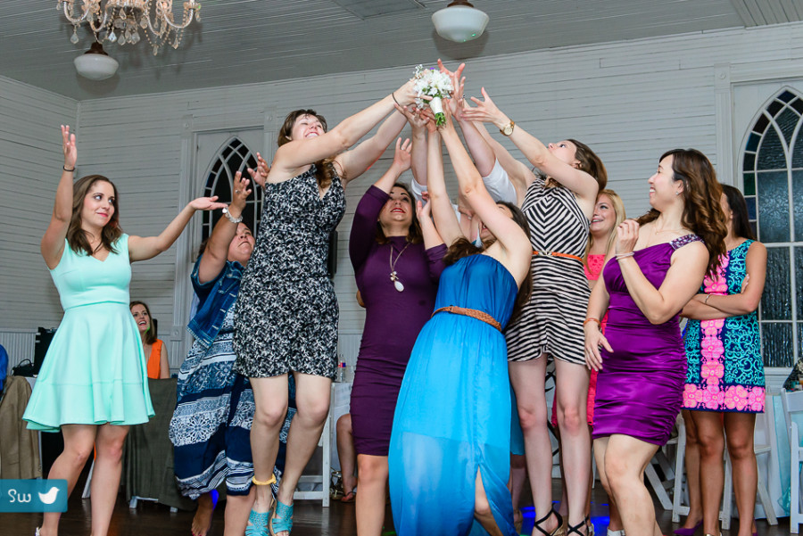 bouquet toss with bridesmaid by austin wedding photographer