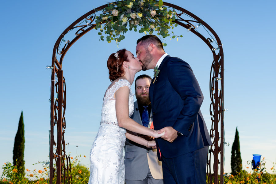 Trellis flowers ceremony outdoor kiss austin wedding photographers