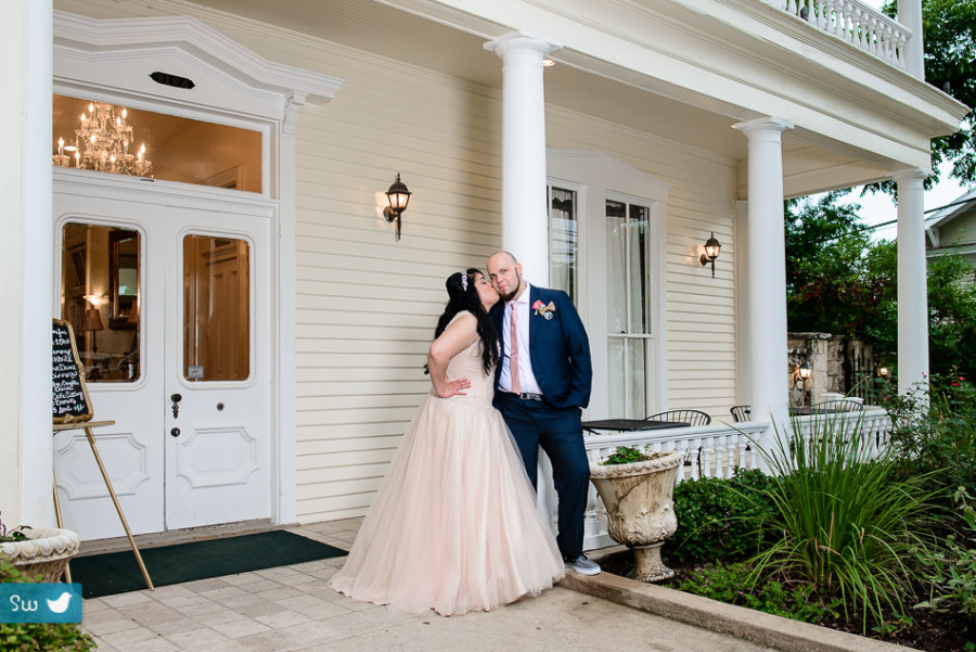 bride and groom in front of Allan House in Austin