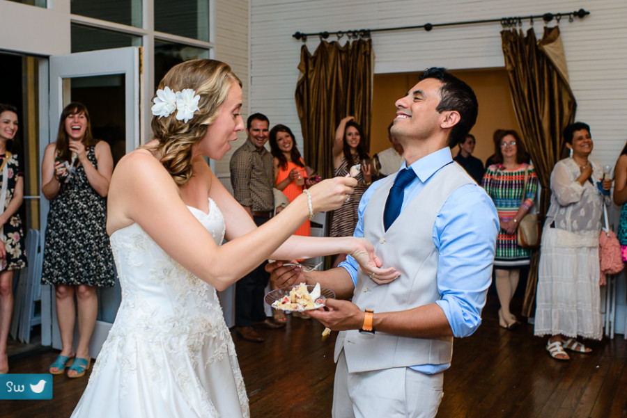 bride spilling cake on groom by austin wedding photographer